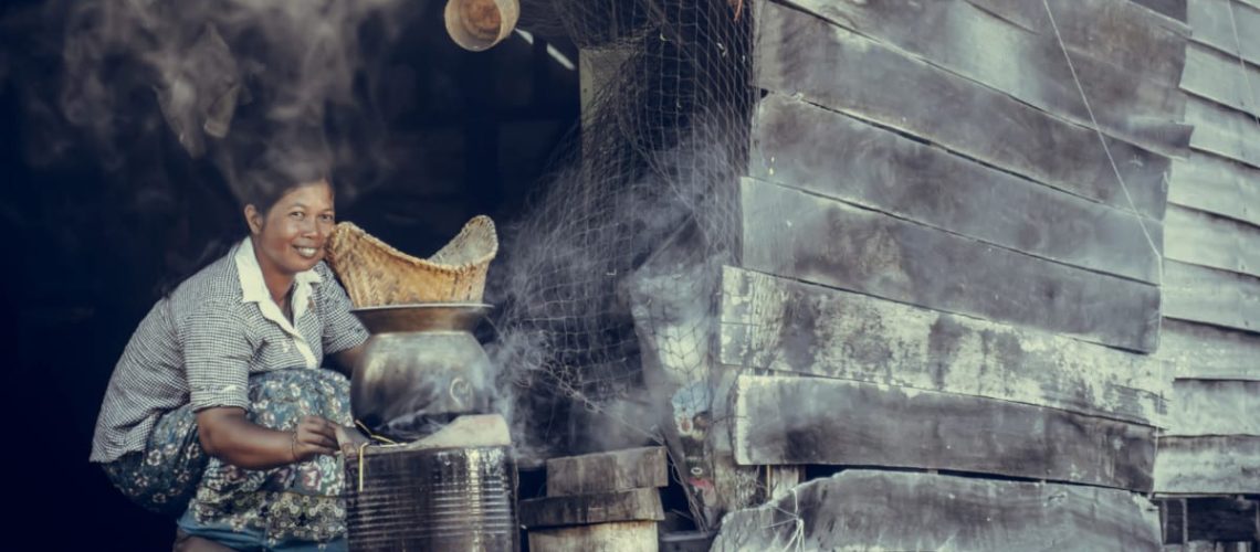 woman cooking outdoors in the village